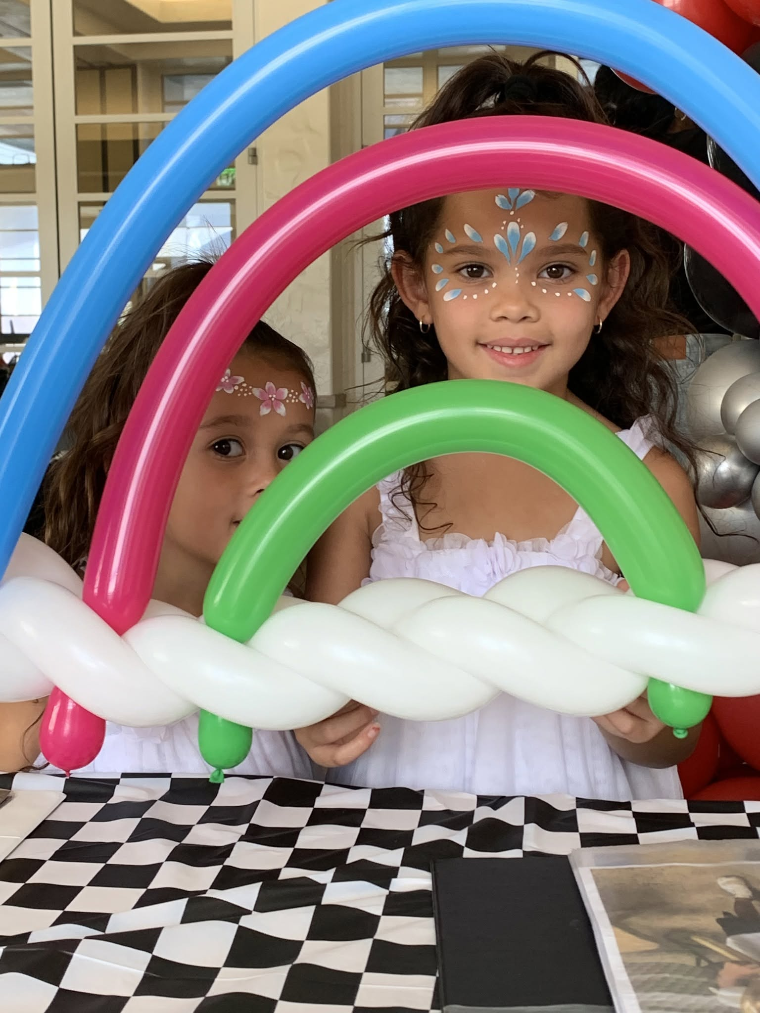 Kids enjoying balloon animals and face paint