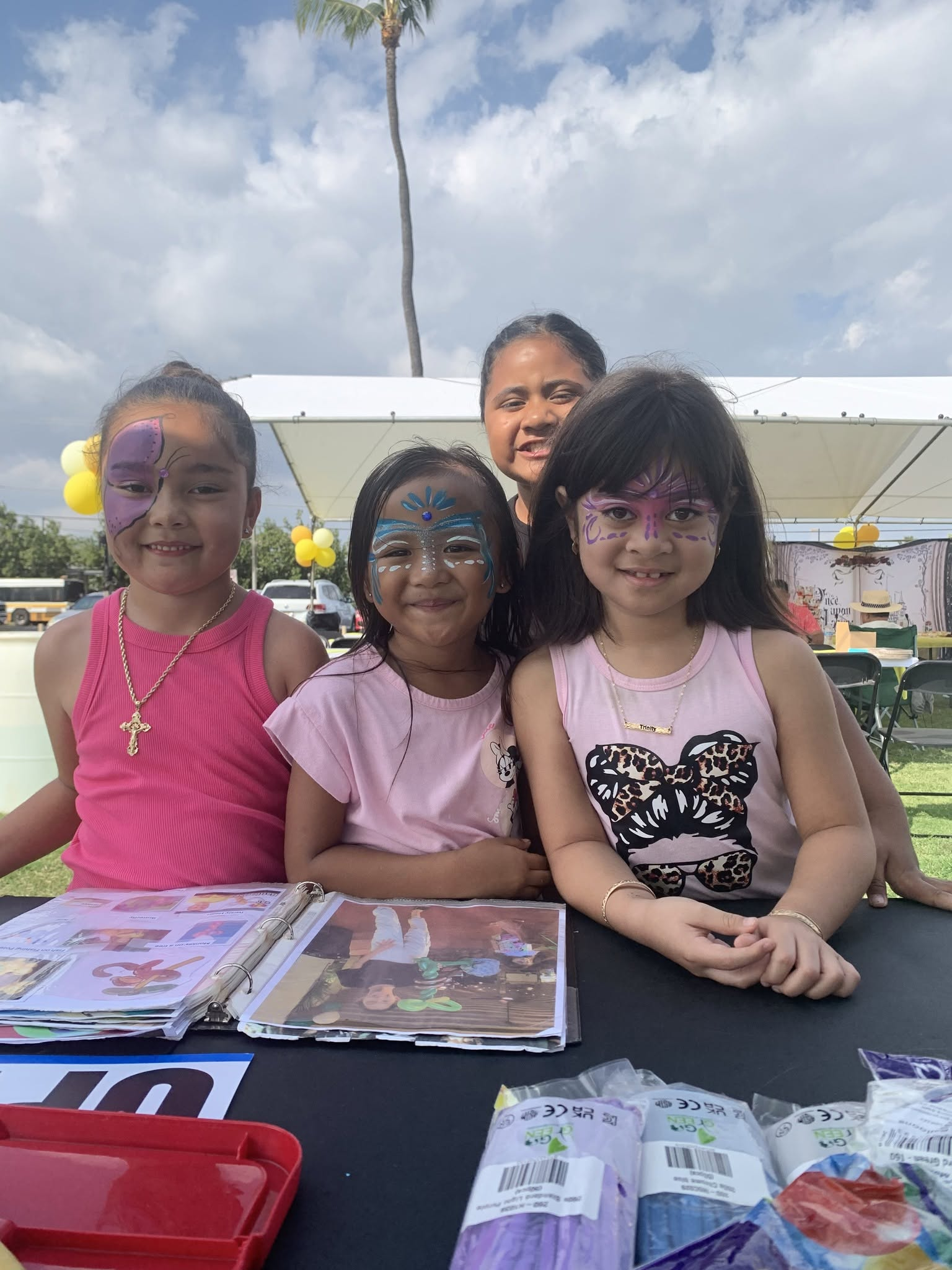 Group of happy kids with colorful face paint designs