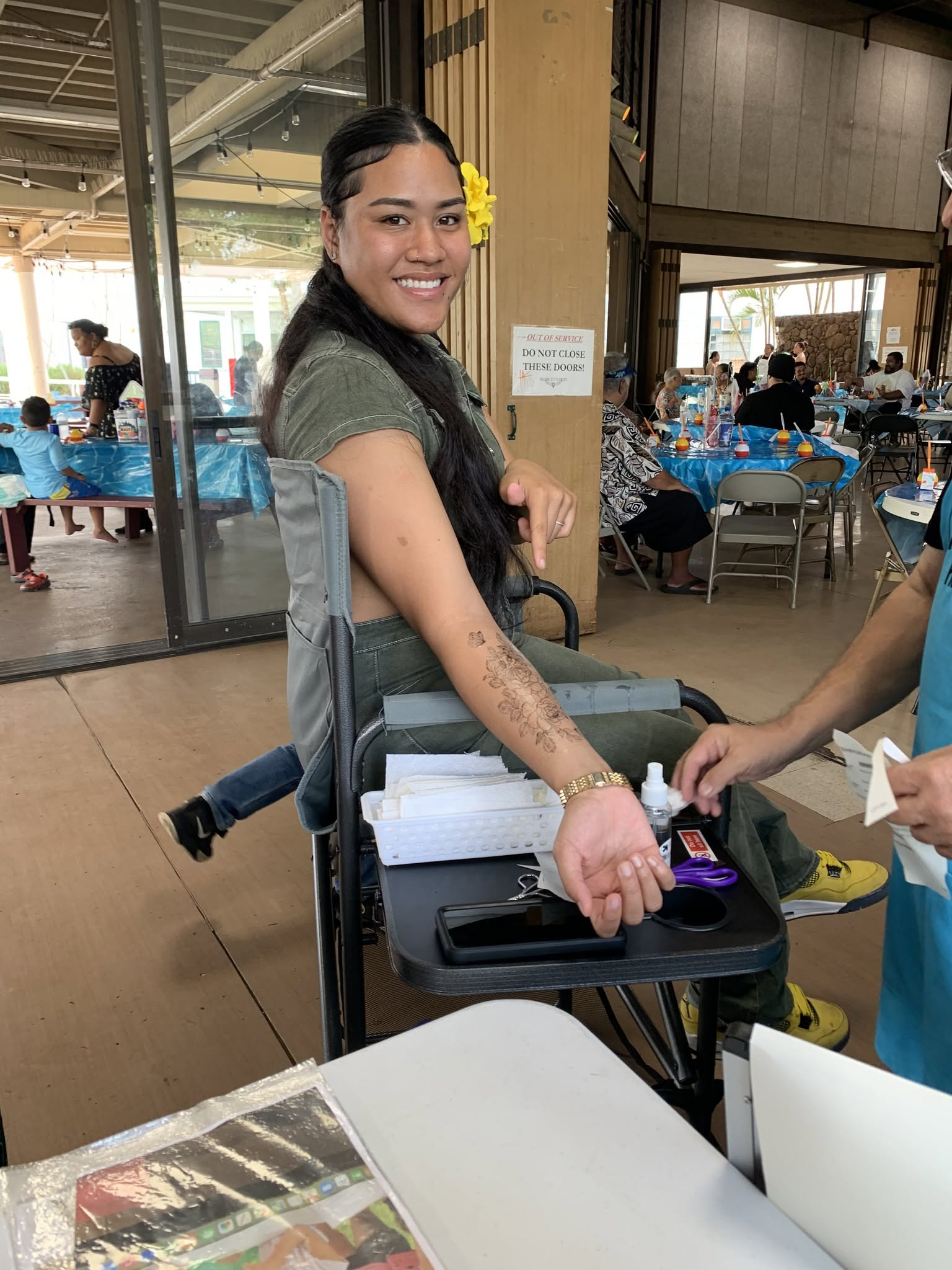 Professional glitter tattoo artist at event